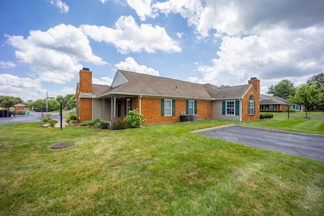 594 Chardonnay Ln, Lewis Center, OH 43035 - single story home with a chimney, brick siding, driveway, and a front lawn