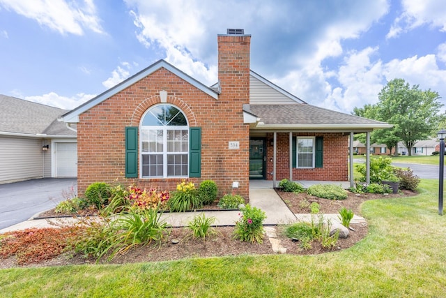 594 Chardonnay Ln, Lewis Center, OH 43035 - ranch-style home featuring brick siding, a shingled roof, a chimney, a front yard, and an attached garage