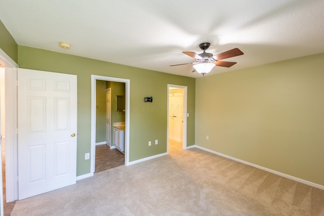 594 Chardonnay Ln, Lewis Center, OH 43035 - unfurnished bedroom with light colored carpet, a spacious closet, connected bathroom, and ceiling fan