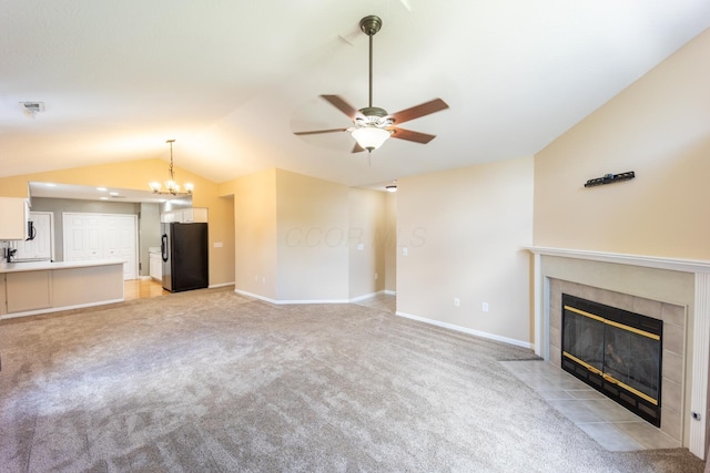 594 Chardonnay Ln, Lewis Center, OH 43035 - unfurnished living room with lofted ceiling, a tiled fireplace, ceiling fan, and light carpet