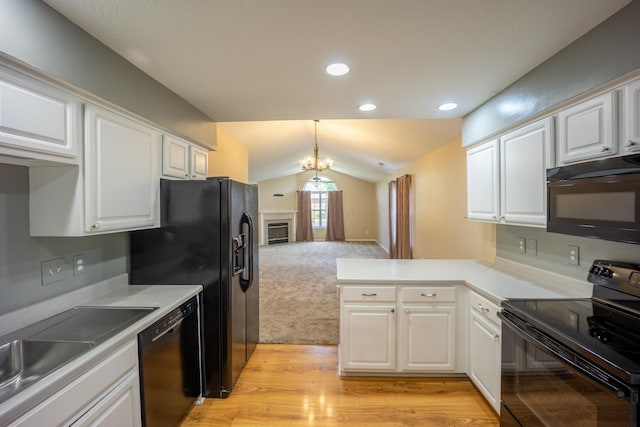 594 Chardonnay Ln, Lewis Center, OH 43035 - kitchen featuring black appliances, lofted ceiling, white cabinets, a peninsula, and pendant lighting