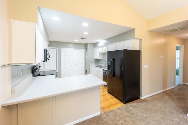 594 Chardonnay Ln, Lewis Center, OH 43035 - kitchen with black refrigerator with ice dispenser, electric range oven, light carpet, a peninsula, and white cabinetry