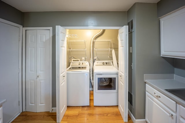 594 Chardonnay Ln, Lewis Center, OH 43035 - laundry area featuring washing machine and clothes dryer and light wood-type flooring