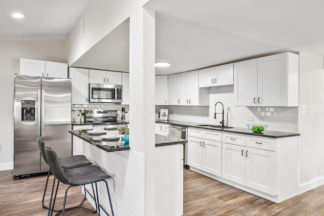 114 N Trine St, Canal Winchester, OH 43110 - kitchen with stainless steel appliances, white cabinetry, decorative backsplash, a breakfast bar, and recessed lighting