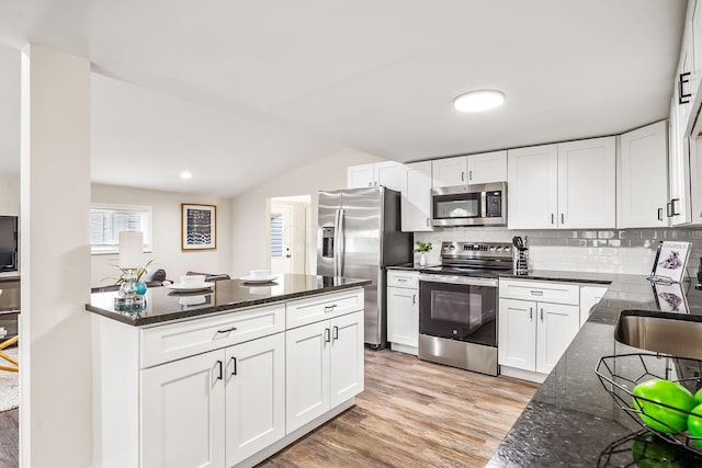 114 N Trine St, Canal Winchester, OH 43110 - kitchen with stainless steel appliances, dark stone countertops, white cabinetry, light wood finished floors, and lofted ceiling
