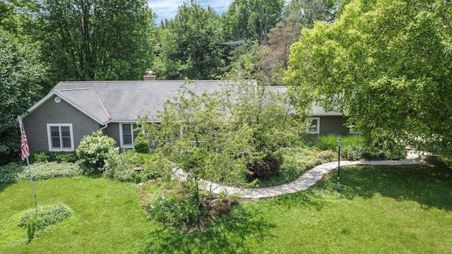 8421 Ransom Rd, Mount Vernon, OH 43050 - view of front of home with a front lawn, a chimney, and roof with shingles