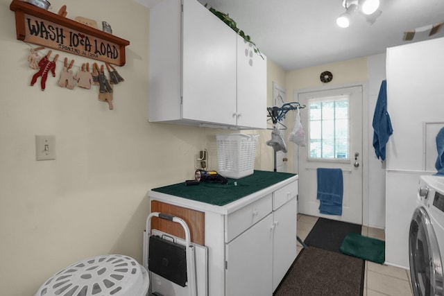 8421 Ransom Rd, Mount Vernon, OH 43050 - laundry area featuring cabinet space, washer / dryer, and light tile patterned flooring