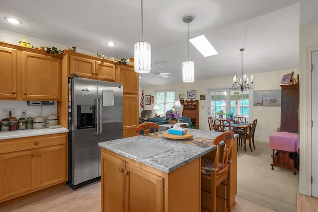 8421 Ransom Rd, Mount Vernon, OH 43050 - kitchen featuring stainless steel refrigerator with ice dispenser, a chandelier, a skylight, a kitchen island, and a ceiling fan