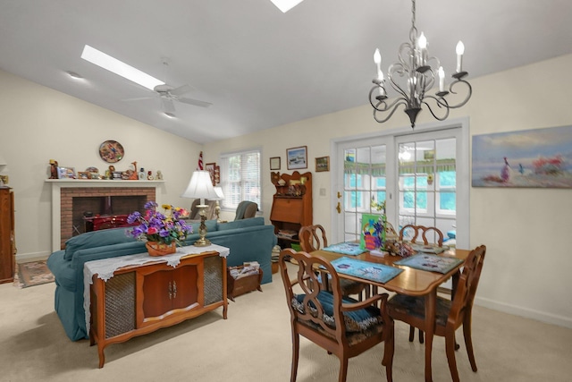 8421 Ransom Rd, Mount Vernon, OH 43050 - dining room featuring light colored carpet, a chandelier, lofted ceiling, ceiling fan, and a brick fireplace
