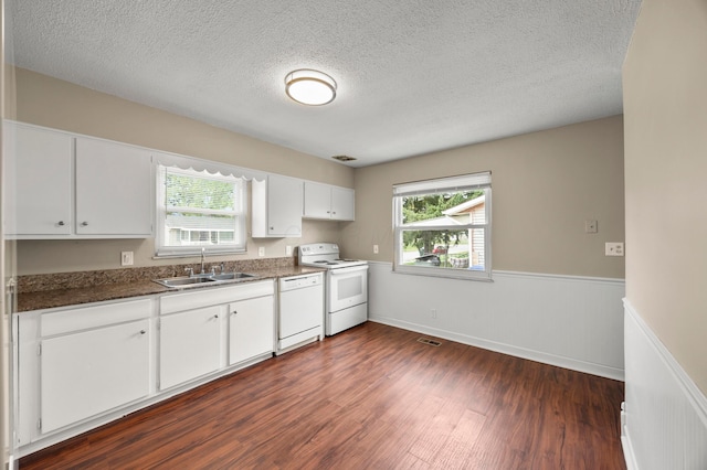 2468 Spaatz Ave, Columbus, OH 43204 - kitchen featuring white appliances, dark wood-type flooring, white cabinetry, a textured ceiling, and wainscoting