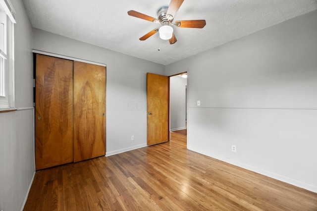 2468 Spaatz Ave, Columbus, OH 43204 - unfurnished bedroom with wood finished floors, a closet, a textured ceiling, and a ceiling fan