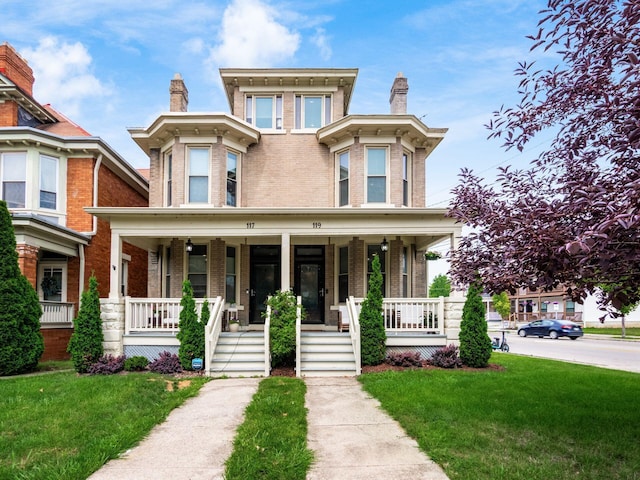 119 Miami Ave Unit 119, Columbus, OH 43203 - view of front of property featuring a porch, brick siding, and a front yard