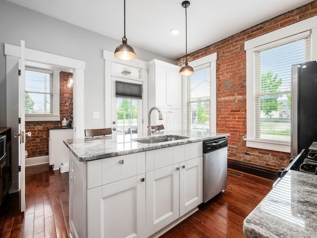 119 Miami Ave Unit 119, Columbus, OH 43203 - kitchen with appliances with stainless steel finishes, brick wall, dark wood-style floors, white cabinets, and light stone countertops