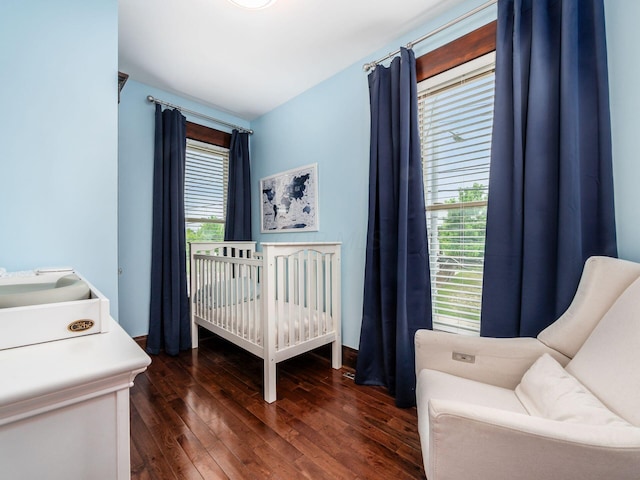 119 Miami Ave Unit 119, Columbus, OH 43203 - bedroom with multiple windows, dark wood-type flooring, and a nursery area