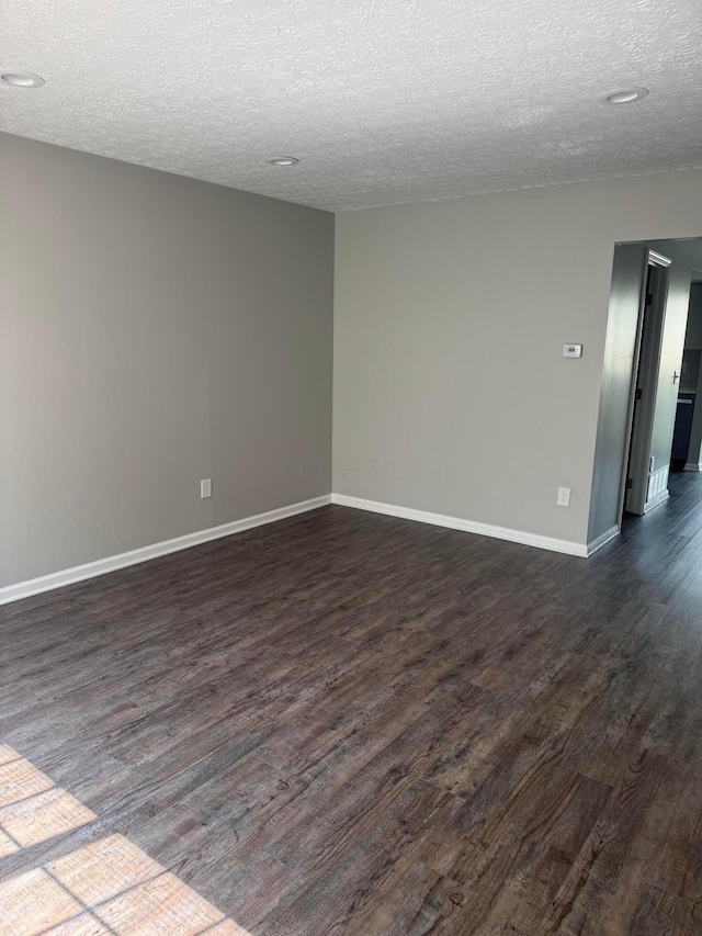 7771 Deercrest Ct, Dublin, OH 43016 - spare room featuring dark wood-type flooring and a textured ceiling