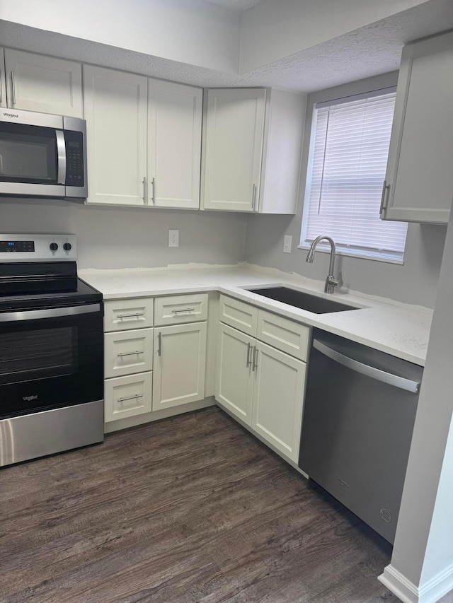 7771 Deercrest Ct, Dublin, OH 43016 - kitchen with stainless steel appliances, light countertops, and dark wood finished floors
