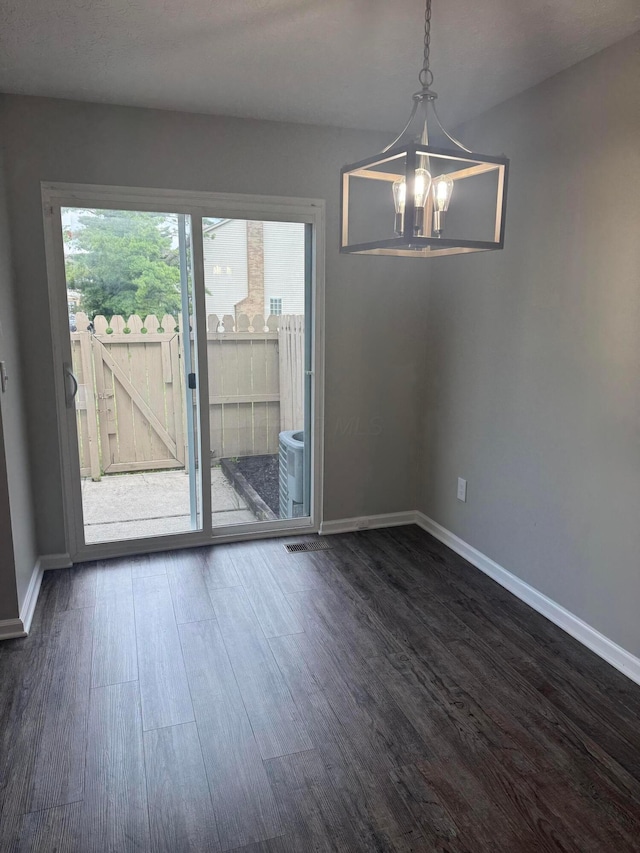 7771 Deercrest Ct, Dublin, OH 43016 - unfurnished dining area featuring healthy amount of natural light, dark wood-type flooring, and a chandelier