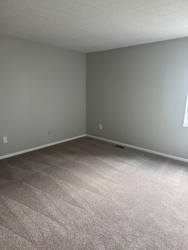 7771 Deercrest Ct, Dublin, OH 43016 - carpeted spare room featuring a textured ceiling