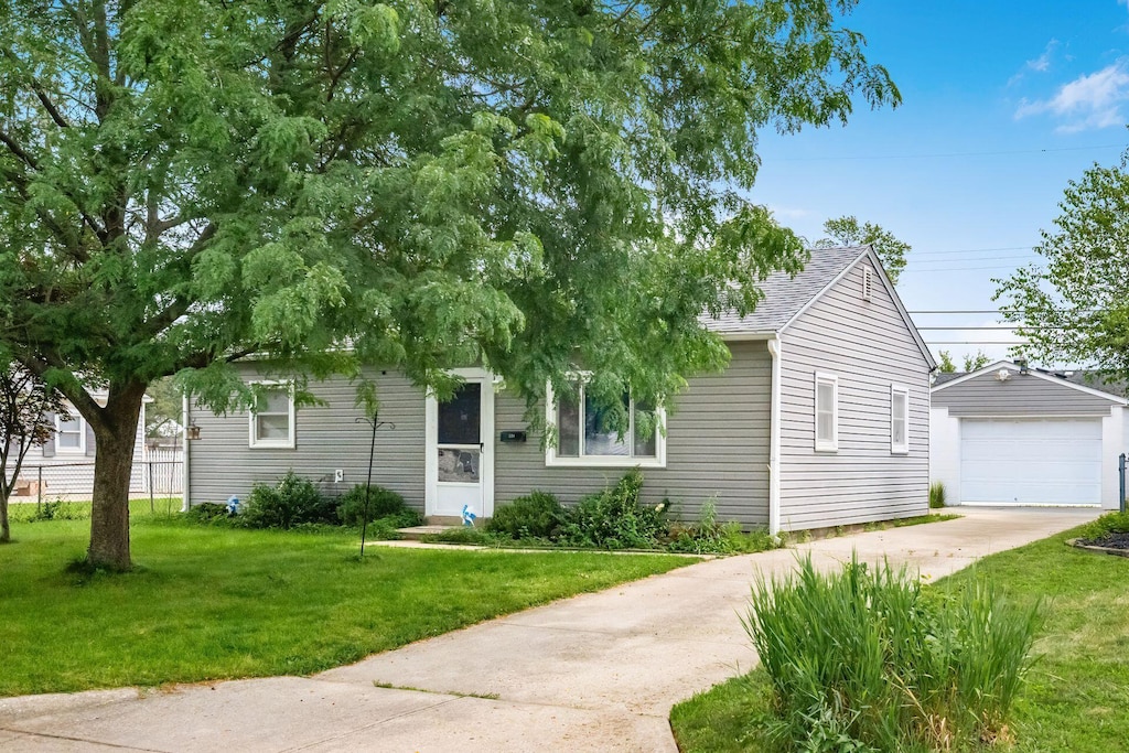 224 Ross Rd, Columbus, OH 43213 - obstructed view of property with an outdoor structure, driveway, a front lawn, a garage, and a shingled roof
