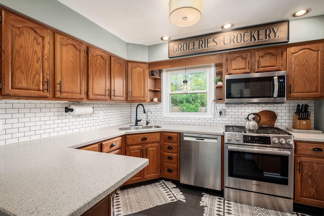 2566 Mcdaniel Ct, Grove City, OH 43123 - kitchen featuring appliances with stainless steel finishes, open shelves, light countertops, brown cabinets, and tasteful backsplash
