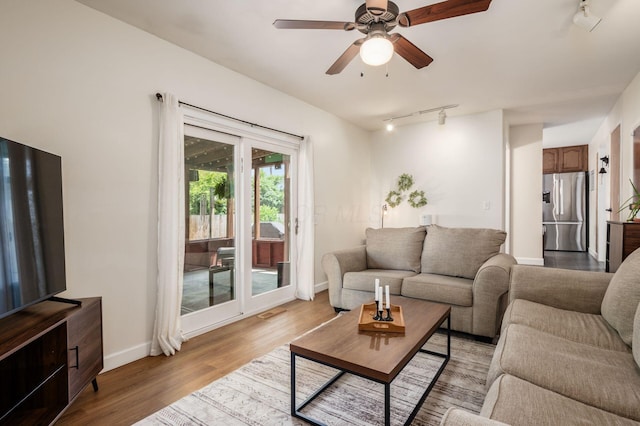 2566 Mcdaniel Ct, Grove City, OH 43123 - living area with a ceiling fan, rail lighting, and light wood finished floors