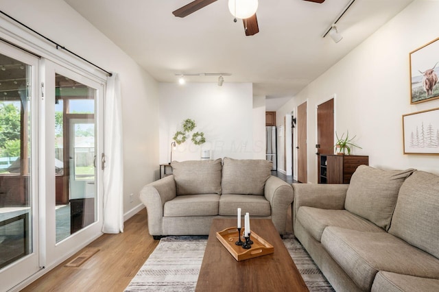 2566 Mcdaniel Ct, Grove City, OH 43123 - living room featuring rail lighting, ceiling fan, and light wood-style flooring