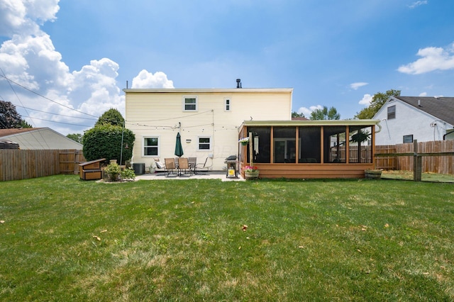 2566 Mcdaniel Ct, Grove City, OH 43123 - rear view of house with a sunroom, a patio, and a fenced backyard