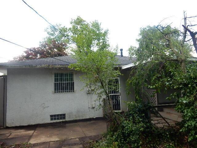 1549 Alpine Dr, Columbus, OH 43229 - back of property featuring a patio, stucco siding, and a shingled roof