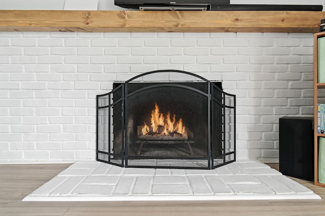 2036 Queensbridge Dr, Columbus, OH 43235 - detailed view of a fireplace, wood finished floors, and brick wall
