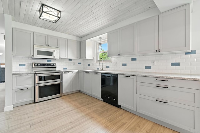 2036 Queensbridge Dr, Columbus, OH 43235 - kitchen featuring white microwave, black dishwasher, double oven range, wooden ceiling, and light wood-style floors