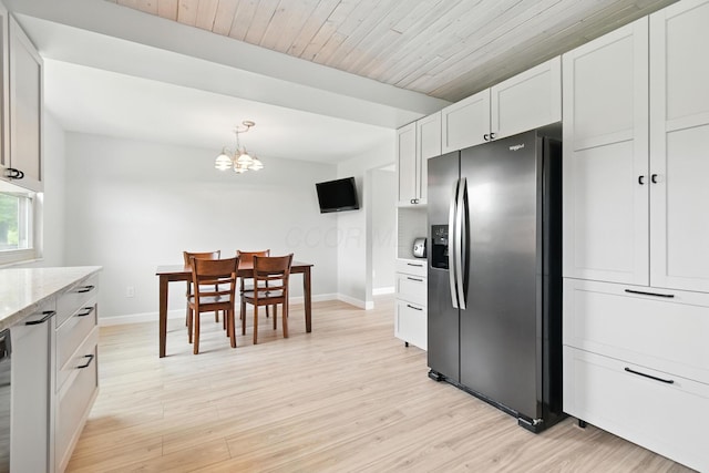 2036 Queensbridge Dr, Columbus, OH 43235 - kitchen with stainless steel refrigerator with ice dispenser, a chandelier, light stone countertops, light wood-style flooring, and white cabinetry