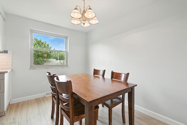 2036 Queensbridge Dr, Columbus, OH 43235 - dining room featuring a chandelier and light wood-style flooring