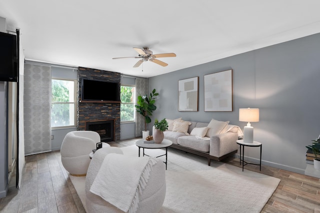 1481 Cliff Ct Unit 58-A, Columbus, OH 43204 - living room with wood finished floors, a ceiling fan, and a stone fireplace