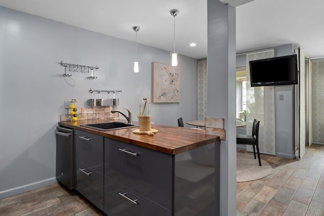 1481 Cliff Ct Unit 58-A, Columbus, OH 43204 - kitchen with butcher block countertops, light wood-style flooring, a peninsula, decorative light fixtures, and modern cabinets