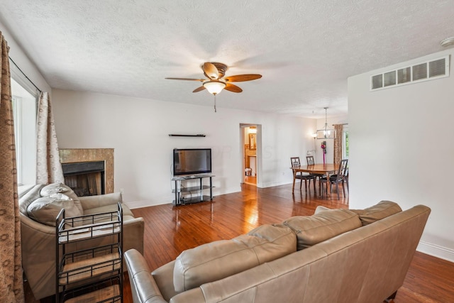 9900 Waterloo Eastern Rd, Canal Winchester, OH 43110 - living area featuring hardwood / wood-style floors, a ceiling fan, a fireplace, healthy amount of natural light, and a textured ceiling