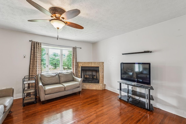 9900 Waterloo Eastern Rd, Canal Winchester, OH 43110 - living area featuring wood-type flooring, a fireplace, a ceiling fan, and a textured ceiling