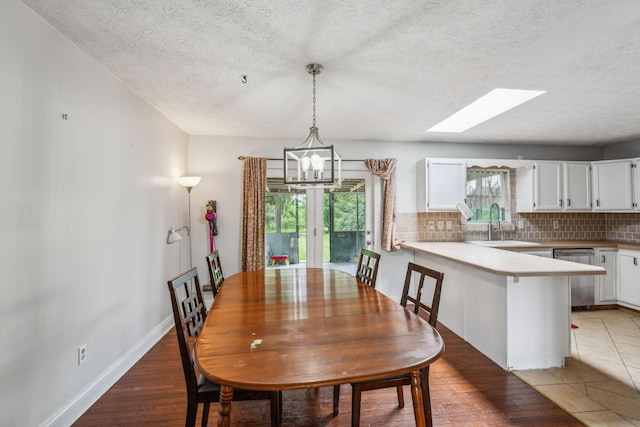 9900 Waterloo Eastern Rd, Canal Winchester, OH 43110 - dining space featuring a chandelier, a textured ceiling, and a skylight