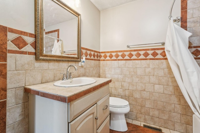 9900 Waterloo Eastern Rd, Canal Winchester, OH 43110 - bathroom featuring tile walls, vanity, a wainscoted wall, and tile patterned flooring
