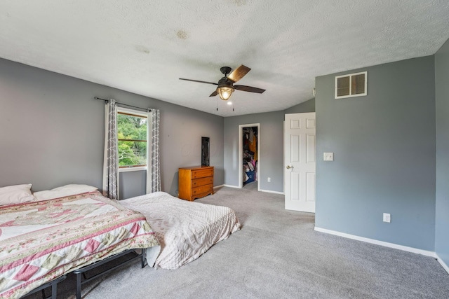 9900 Waterloo Eastern Rd, Canal Winchester, OH 43110 - carpeted bedroom featuring a walk in closet, ceiling fan, and a textured ceiling