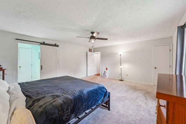 9900 Waterloo Eastern Rd, Canal Winchester, OH 43110 - bedroom with carpet floors, a barn door, a textured ceiling, and a ceiling fan