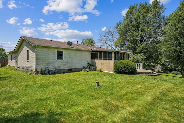 9900 Waterloo Eastern Rd, Canal Winchester, OH 43110 - back of house with a sunroom, brick siding, a wooden deck, and a yard