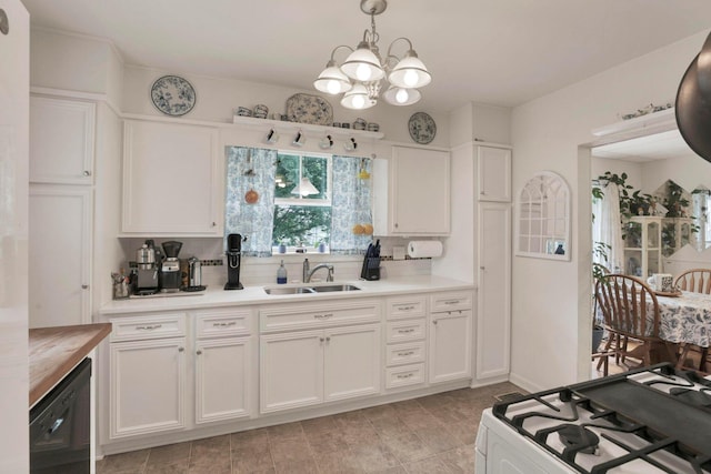 220 Robinwood Ave, Columbus, OH 43213 - kitchen featuring white range with gas stovetop, tasteful backsplash, a chandelier, and light countertops