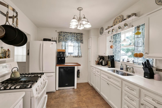 220 Robinwood Ave, Columbus, OH 43213 - kitchen featuring white appliances, healthy amount of natural light, a chandelier, and white cabinets