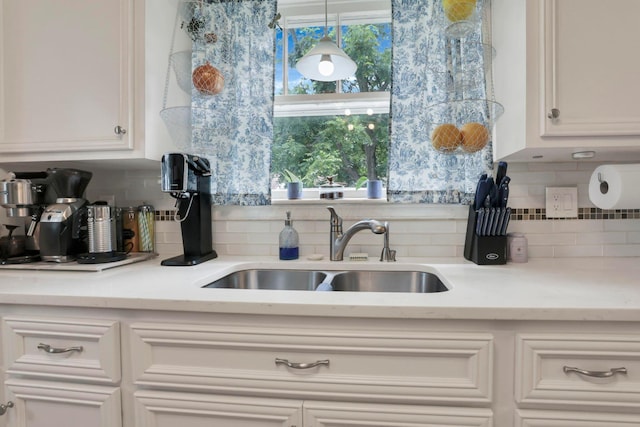 220 Robinwood Ave, Columbus, OH 43213 - kitchen featuring tasteful backsplash, light countertops, and white cabinets