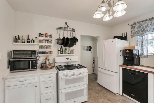 220 Robinwood Ave, Columbus, OH 43213 - kitchen with white appliances, a chandelier, white cabinets, light countertops, and light tile patterned floors