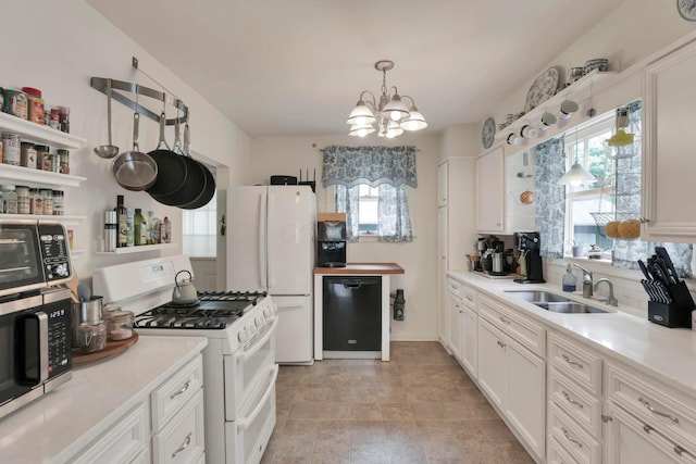 220 Robinwood Ave, Columbus, OH 43213 - kitchen featuring white appliances, a chandelier, light countertops, and white cabinets