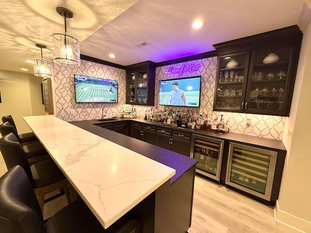 2000 Forestview Ln, Delaware, OH 43015 - indoor wet bar with beverage cooler, decorative backsplash, light wood-style floors, and recessed lighting