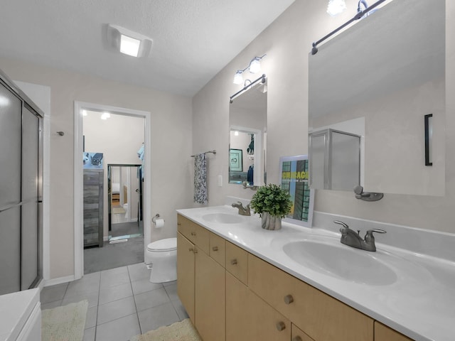 1235 Shagbark Rd, Columbus, OH 43230 - full bath featuring double vanity, tile patterned flooring, and a shower with shower door