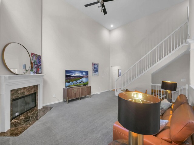 1235 Shagbark Rd, Columbus, OH 43230 - living area with ceiling fan, carpet flooring, stairs, a high ceiling, and a premium fireplace
