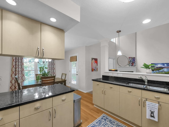 1235 Shagbark Rd, Columbus, OH 43230 - kitchen with dark stone countertops, ornate columns, light wood-style floors, cream cabinets, and recessed lighting